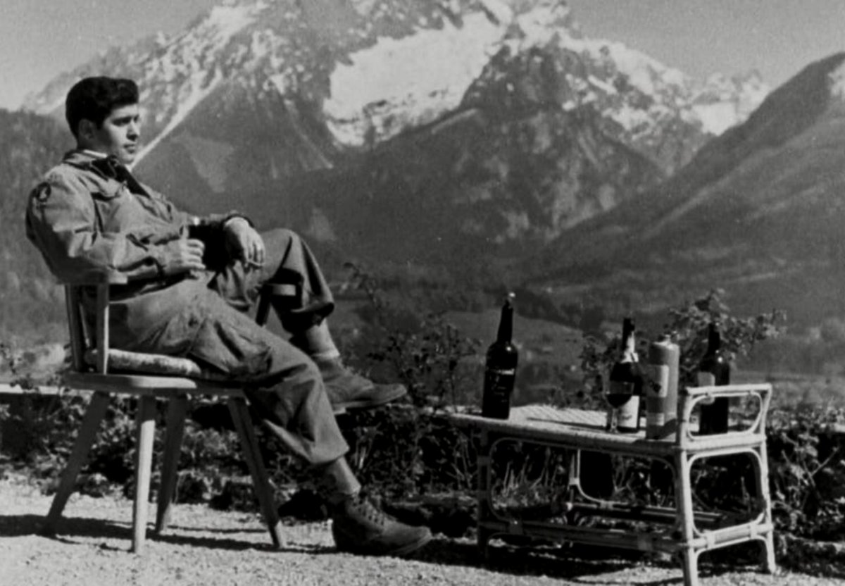 American paratrooper drinks the departed Hitler’s cognac on patio of Hitler's Alpine retreat at Berchtesgaden, spring 1945:              #NARA