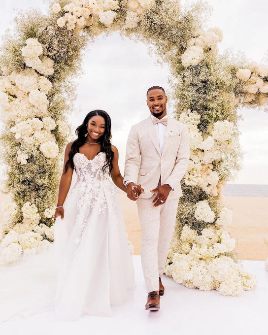 Photo of 7-time Olympic gymnastics medalist Simone Biles and Houston Texans safety Jonathan Owens smiling at their ceremony at their destination wedding in Mexico.