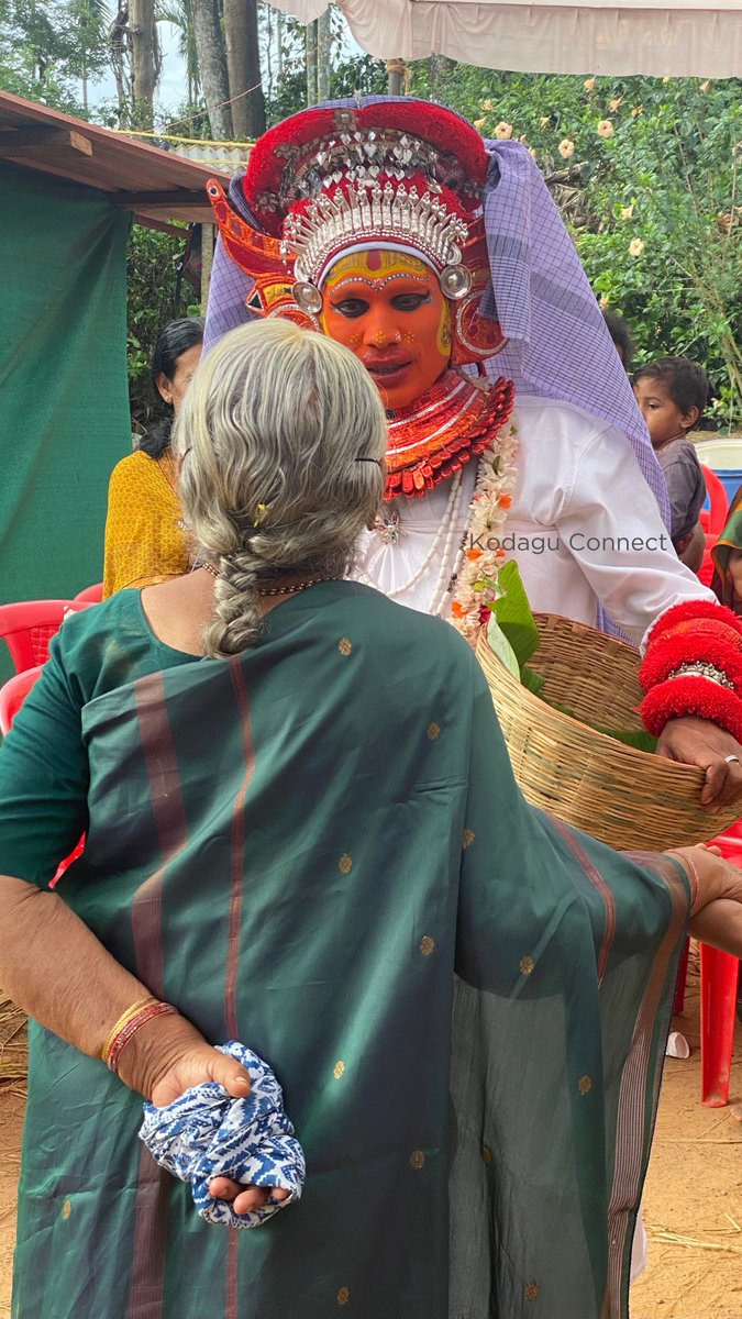 Kodavas are ancestor worshippers and belong to different clans (okka). The first ancestor of the clan is revered as a god. The ajjas (fathers) and thaayis (mothers) are worshipped in a ritual form. The above photo is of a thaayi taking to an old lady from the clan.