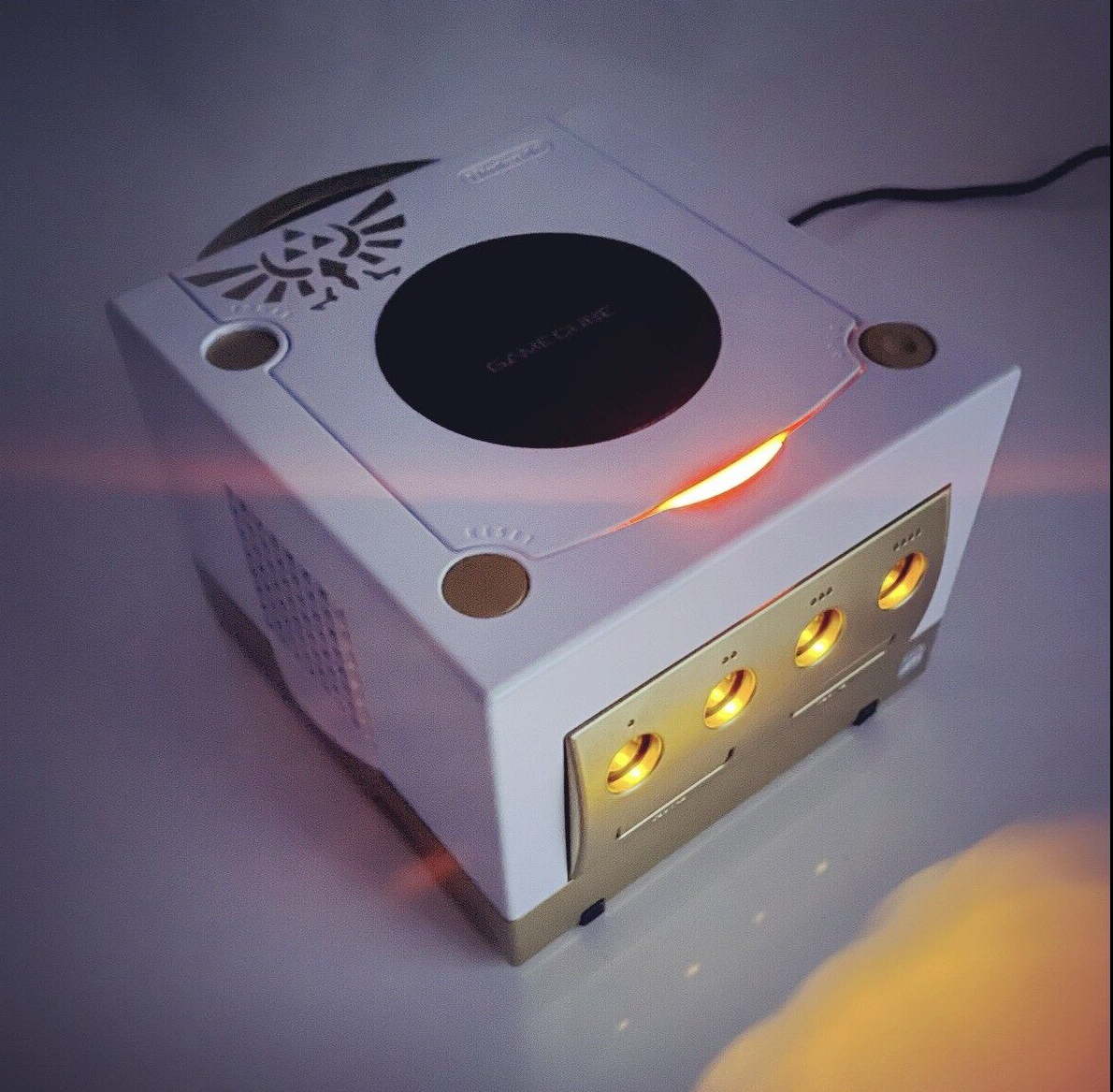 extremeconsoles's tweet photo. It's all about Zelda this week... 

📸 Gold and white GameCube with a Zelda theme

#Zelda #Nintendo #GameCube #RETROGAMING #customconsole https://t.co/ArY0zQCJ3x