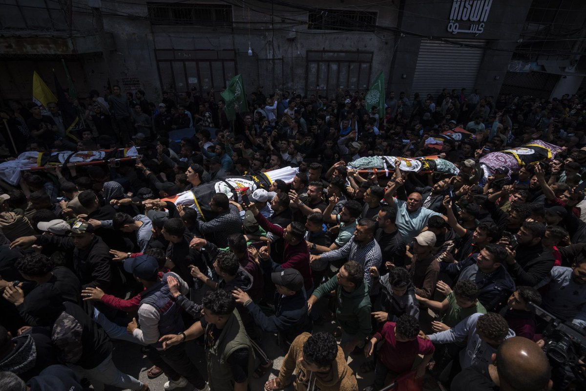 Relatives mourn over the bodies of Khalil Bahtini, the Islamic Jihad militant group's commander for the northern Gaza Strip, his wife and son, who were killed in an Israeli airstrike at their family home in Gaza City, Tuesday, May 9, 2023. (AP Photo/Fatima Shbair)