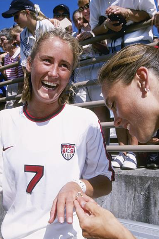 frankmSounders's tweet photo. #OTD 1997 – WA's Justi Baumgardt and Michelle French, both still playing at U of Portland, feature in USWNT's 6-0 victory over England at Portland's Merlo Field. It's French's 1st cap and Tote Yamada kneels and proposes to Baumgardt (pic) on-field following final whistle. https://t.co/BlWVk4LKPg