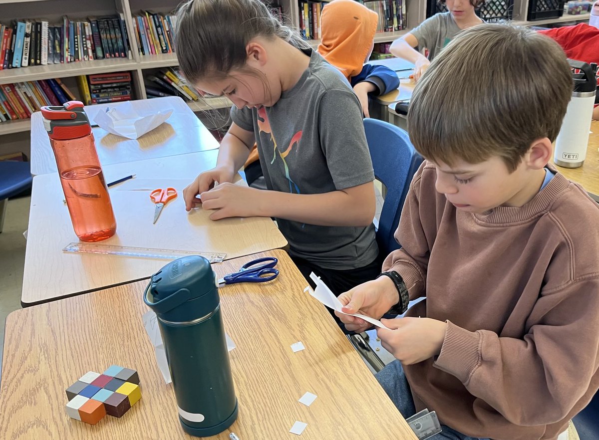 AvonHahn's tweet photo. Engineers at work exploring buoyancy - the paper boat challenge. Tomorrow we will have round 2 and see if students can make changes and create a boat that will hold more weight. https://t.co/B7XFM6I7pU