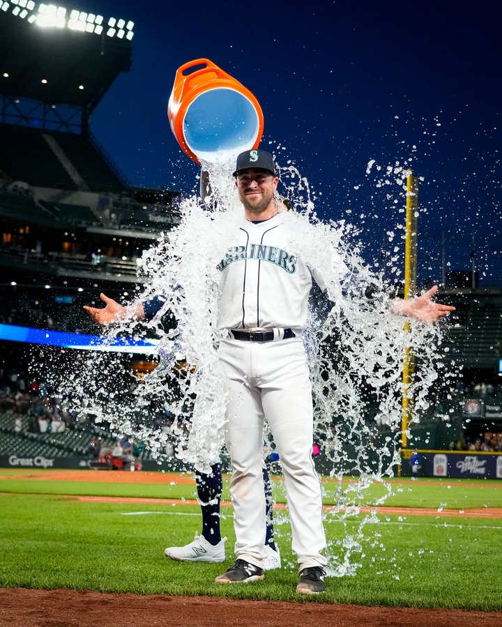 AJ Pollock dumps water on Tom Murphy, with arms outstretched, after the win. 