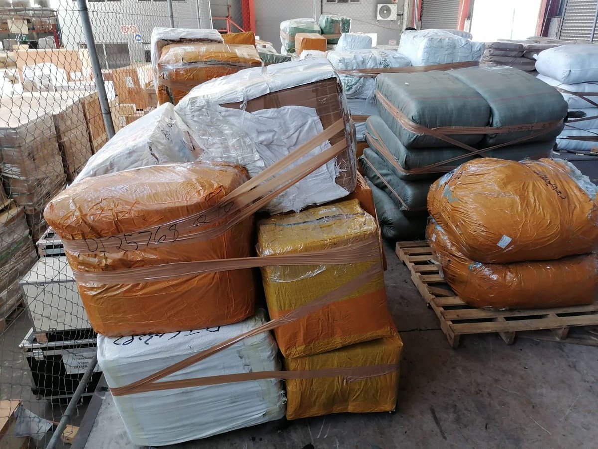 ewnreporter's tweet photo. [PICTURES] SA Police Service officers have seized a container at the Durban Harbour carrying counterfeit items of luxury clothing brands. 

Police estimate the goods to be worth about R400 million. 

Police said the container came from Asia. TCG https://t.co/oYBsZ58qiu