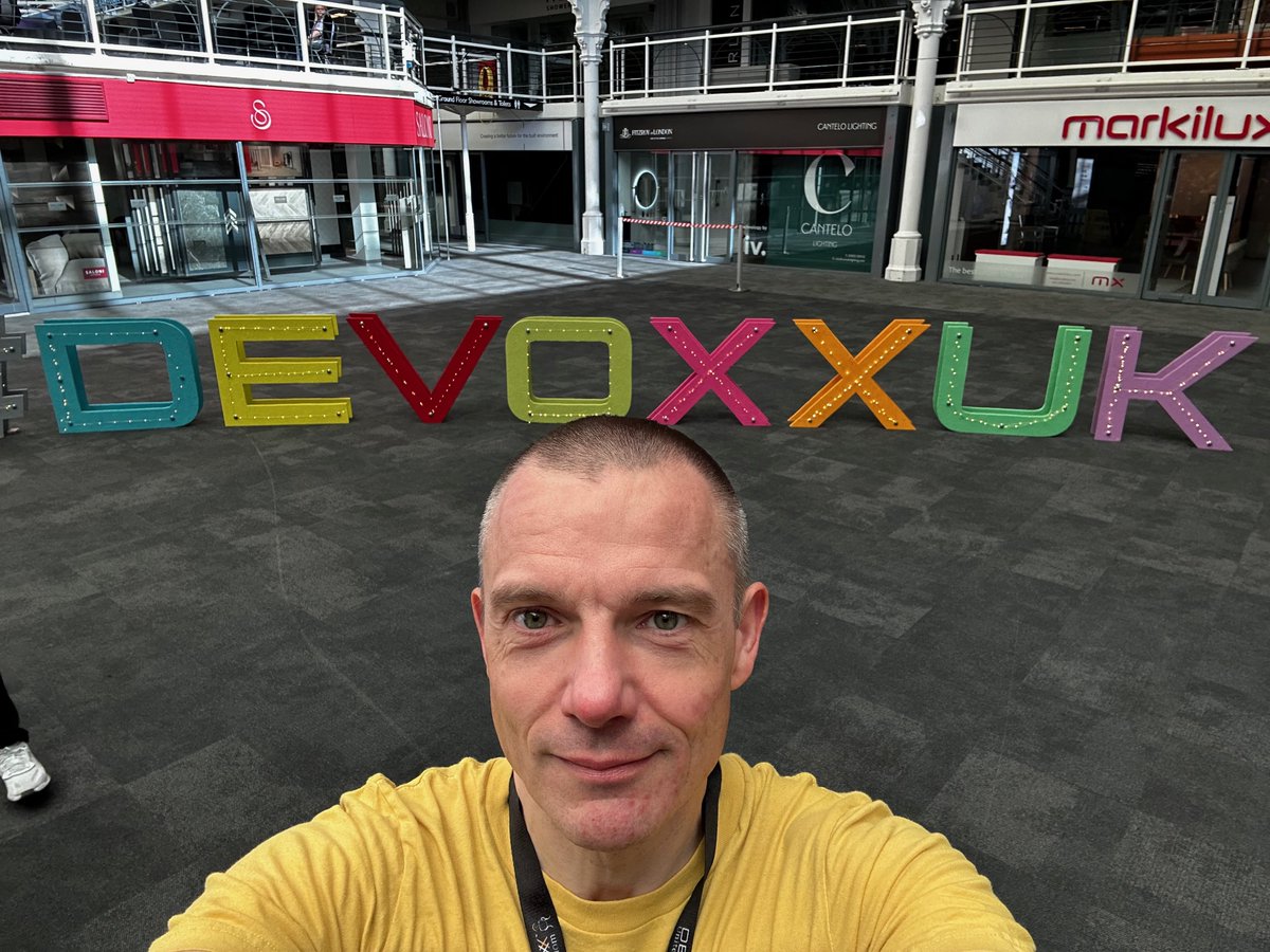 Happy to be at @DevoxxUK! As I found out later, my choice of a yellow t-shirt was unfortunate: The conference helpers have yellow t-shirts, too. But as my t-shirt reads, “I love coding and maybe 3 people”, nobody mistakes me for a helpful person. Or even a friendly one! 😉