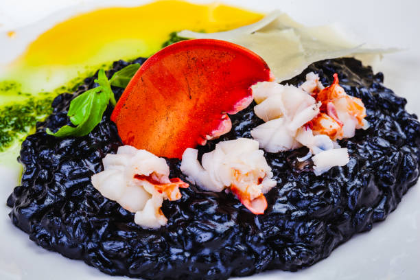 RusticoItaliano's tweet photo. Our #Risotto Nero is black risotto with sea scallops, shrimp, calamari, &amp; lobster tail in white sauce. The core of the Risotto Nero is squid ink. The squid, braised in its own ink and wine. And then you have the rice, which started off simply &amp; then mingled with the squid sauce. https://t.co/LGYwweNlLw