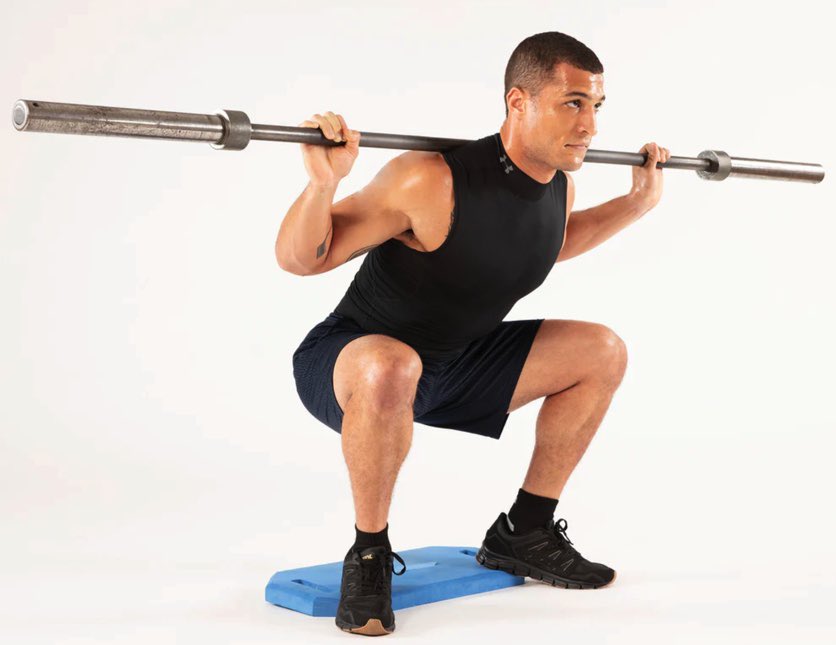 wolfpackstrngth's tweet image. Heel elevation doesn’t automatically make a squat exercise more quad biased. You have to actively push your knees forward and go into more knee flexion, the elevated heel just allows you to do that better.