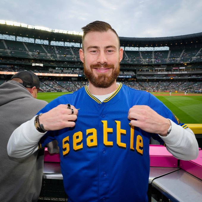 Philipp Grubauer poses in a Mariners City Connect jersey at T-Mobile Park.