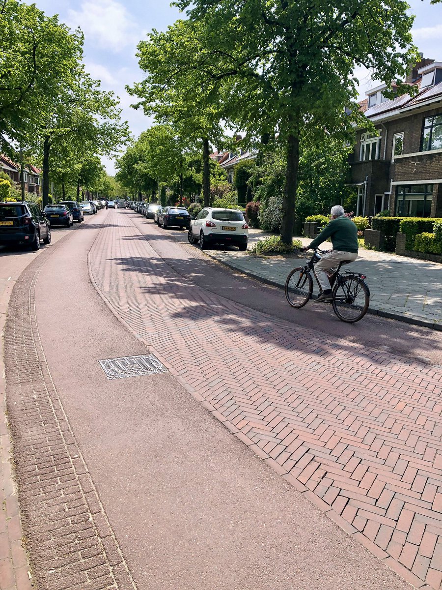 Bricks don’t just make for a prettier street; they make for a slower street. By increasing noise and vibration inside a motor vehicle, the driver is tricked into thinking they’re speeding and voluntarily slows down. (Note the smooth surface for rolling provided on either side.)