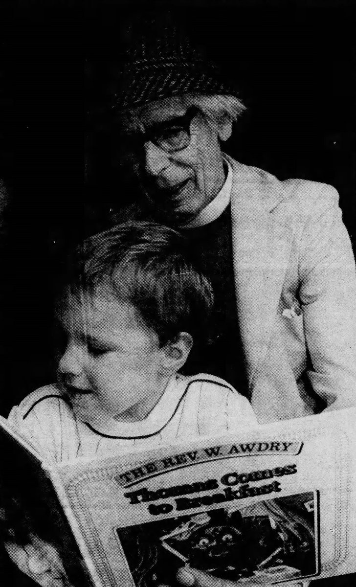 The Reverend Wilbert Awdry reads two-year-old Scott Birch "Thomas Comes to Breakfast" at the Cadeby Steam Open Day.

The Hinckley Times, August 7 1987