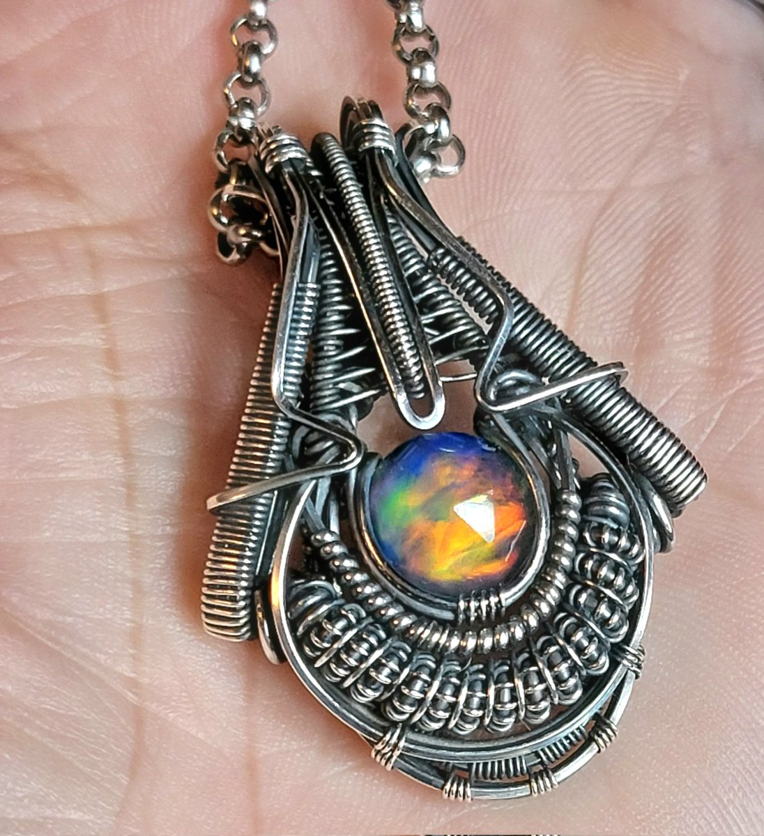 Aurora opal (in sterling and argentium silvers) available at leetwraps.com  #art #artist #starvingartist #wirewrap #wirewrapped #wirewrappedpendant #headywirewrap #heady #symmetry #handmade #wirewrapping