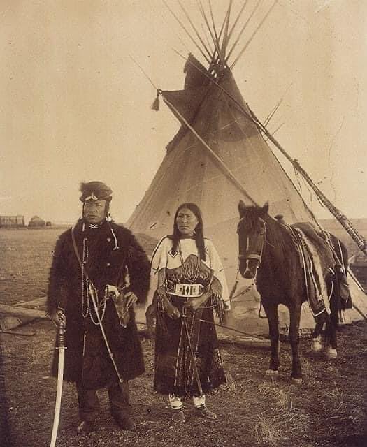 Dog Child, a North West Mounted Police scout, and his wife, The Only Handsome Woman, members of the Blackfoot Nation, Gleichen, Alberta, ca. 1890.