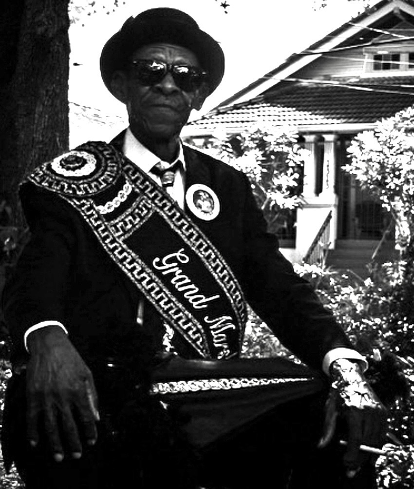 The grand marshal of the Treme Brass Band with umbrella in his lap, finishes his cigarette before leading the band. Today was a special second line, celebrating the official dedication of the Walter Wolfman Washington Memorial Park on Esplanade Avenue.
#NOLA