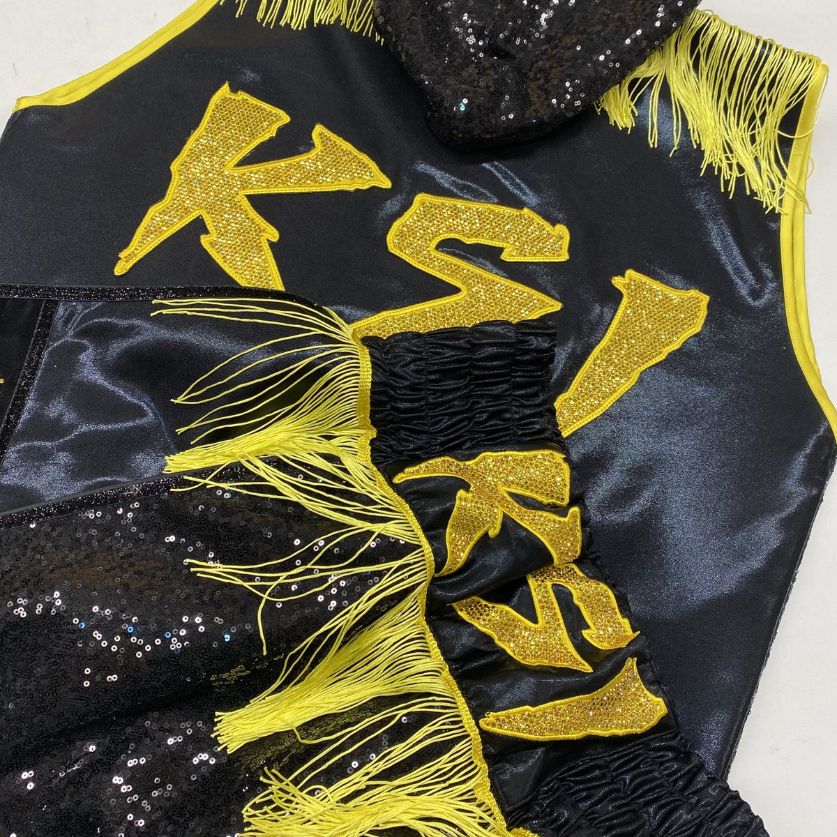 KSI is in the Ring! Wearing a Black &amp; Yellow Combination, crystals and sequins are taking over this kit! Using wetlook and tassel accents, this is a statement piece to enter the fight with! The colours on this boxing kit really POP! 

Get in touch and design your dream kit today!