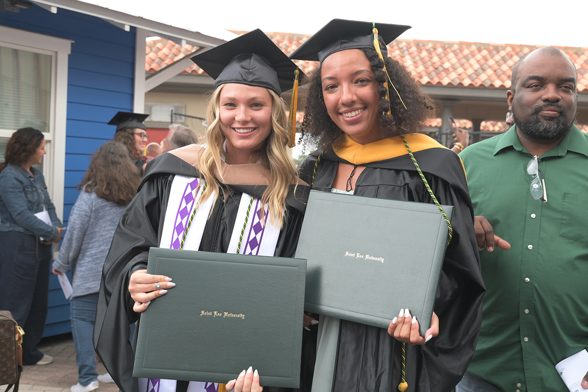 SaintLeoUniv's tweet photo. Trustee and alumnus Kevin Sullivan ’13 officially welcomed this afternoon’s graduates to the alumni association. "You may now turn your tassels from right to left. In doing so, please note that the tassel is over your heart. May Saint Leo always be within your heart." https://t.co/3XRVilLB2Y