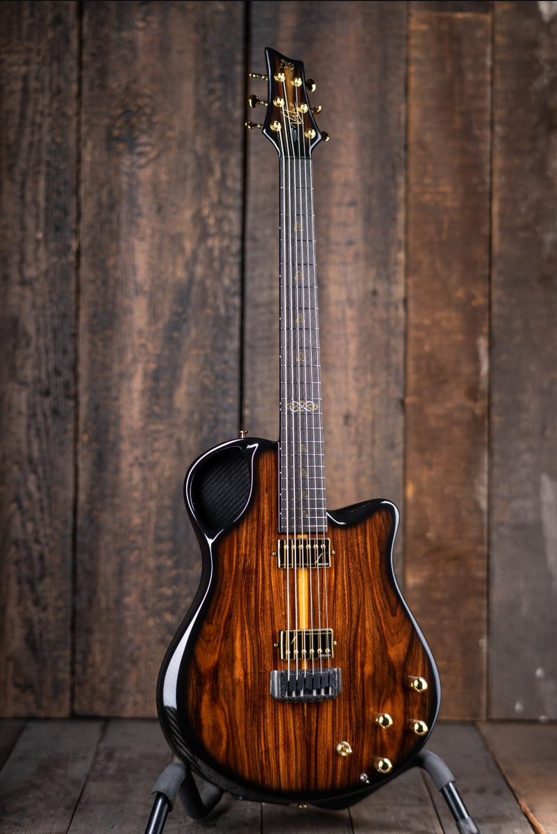 My new Emerald Virtuo electric-acoustic carbon fiber guitar. Pau Ferro veneer, gold hardware, gold Trinity Knot inlays,  Fishman Fluence humbuckers/ single coil split, pull OD boost, 6 Ghost Piezos, Midi output, multiple volume and tone controls for blending all three sounds.