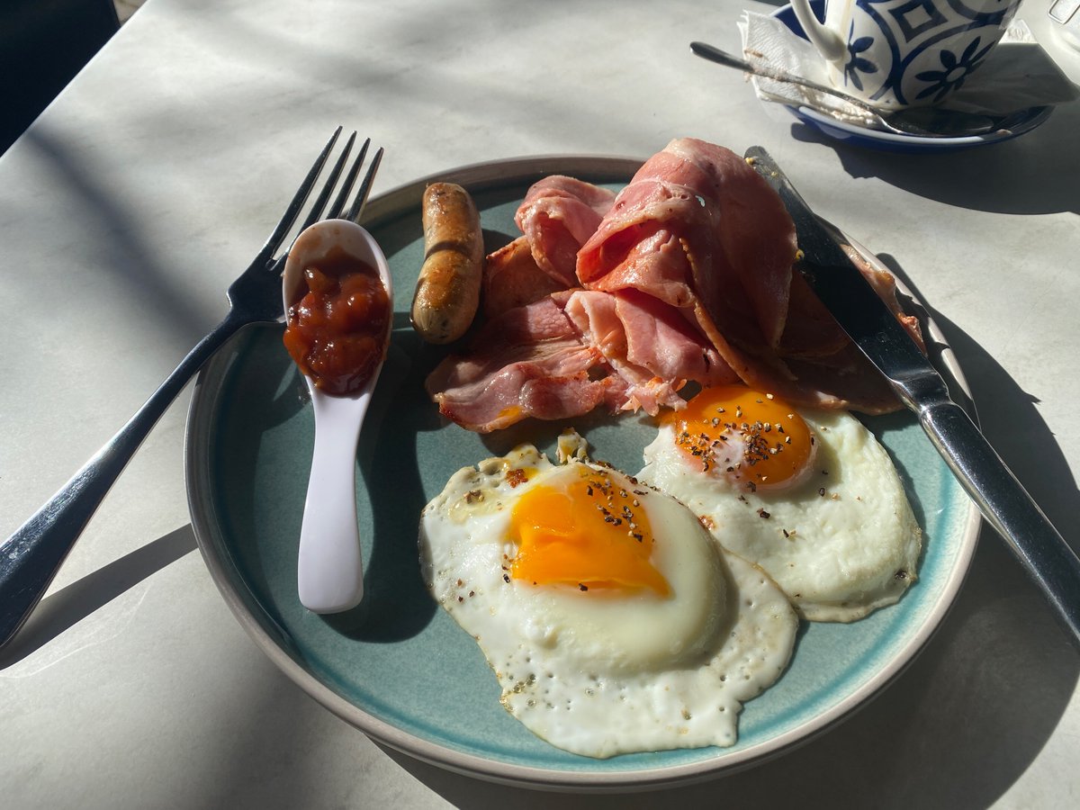 CarbSurvivor's tweet photo. Mother’s Day breakfast out. Bacon and eggs on Sourdough. By sourdough I mean go ahead and swap that shite for more bacon and a sausage thanks. #lchf #eatingout #alwaysOptions https://t.co/Q7G3Spq7iy