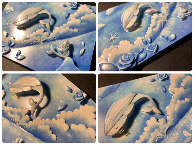 はるさん( )イラストのシャドーボックスを色んな角度から撮影しました。  もくもくとした雲の存在感、水面から飛び出した王様クジラの躍動感、青い薔薇の花と葉などはるさんの描く青い世界をそのまま立体加工しています。