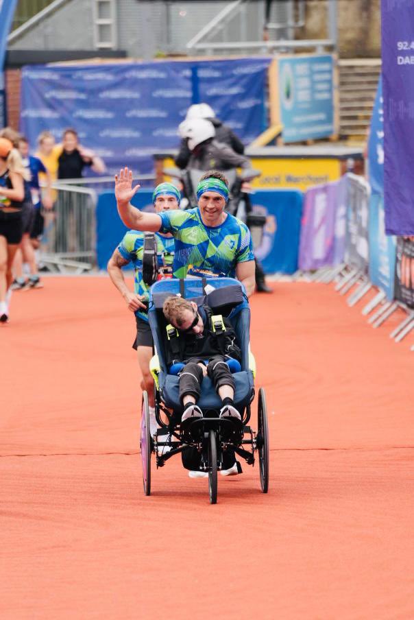 LDShospcharity's tweet photo. The emotional moment when Kevin carried @Rob7Burrow across the finish line of the first-ever Rob Burrow Leeds Marathon 🥹

“Run for a mate, with a mate.” The amazing power of friendship. 💜

#RunForRob #RobBurrowLeedsMarathon 

Photo credit: Tim Zoltie - TZ photography https://t.co/VRa7V0BUKb