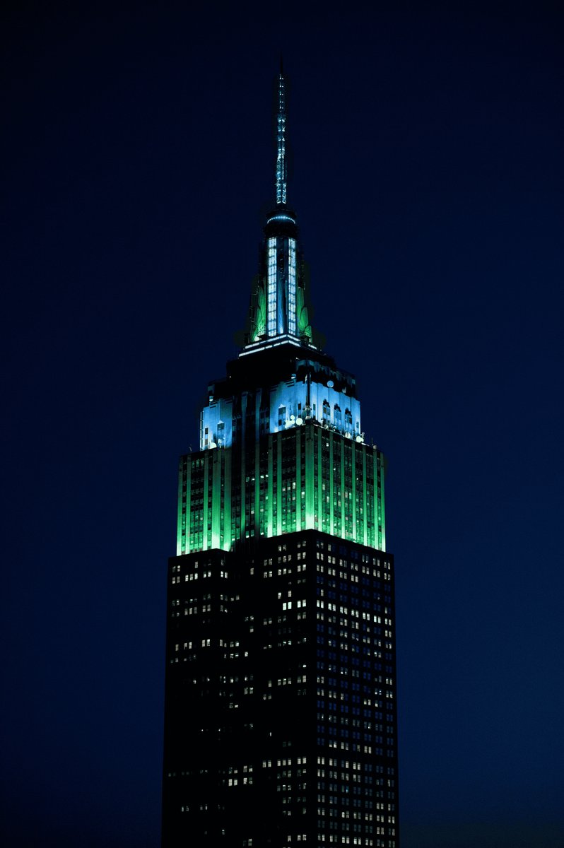 EmpireStateBldg's tweet photo. Glowing in green and blue this evening  in honor of World NF Day @ChildrensTumor https://t.co/I9kX1jnwmf