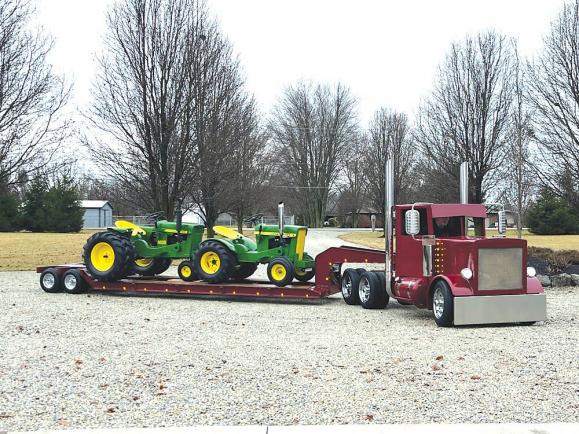FarmShow's tweet photo. Viewed from ground level through a smartphone camera, the Bayer semi-tractor pulling a low boy trailer with a Deere dozer on board looks like a genuine Peterbilt over-the-road rig. #lowboytrailer #peterbilt #trailer #semitractor #model https://t.co/mUWJSEwpzx https://t.co/MdaEv2f8Y7