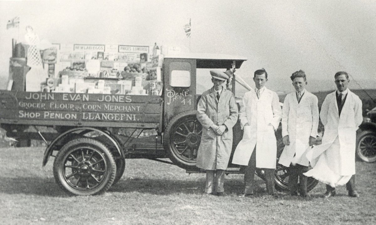 We have started to prepare for our stand at Anglesey Agricultural show coming up in August so I'm sharing this image of the staff and vehicle of John Evan Jones, Siop Pen Lôn, Llangefni [c. 1910] at one of our local shows. #EYALocal @angleseycouncil