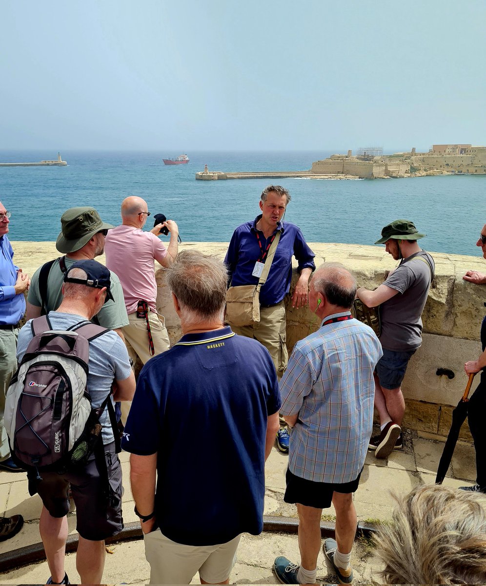 MikeHistorian's tweet photo. Fortress Malta - the story told in epic style by @James1940 to our international group from @WeAreTripsmiths 
Quite a few @WeHaveWaysPod members, too. What a backdrop for the Malta story to be told against. https://t.co/DPBAydYL9a