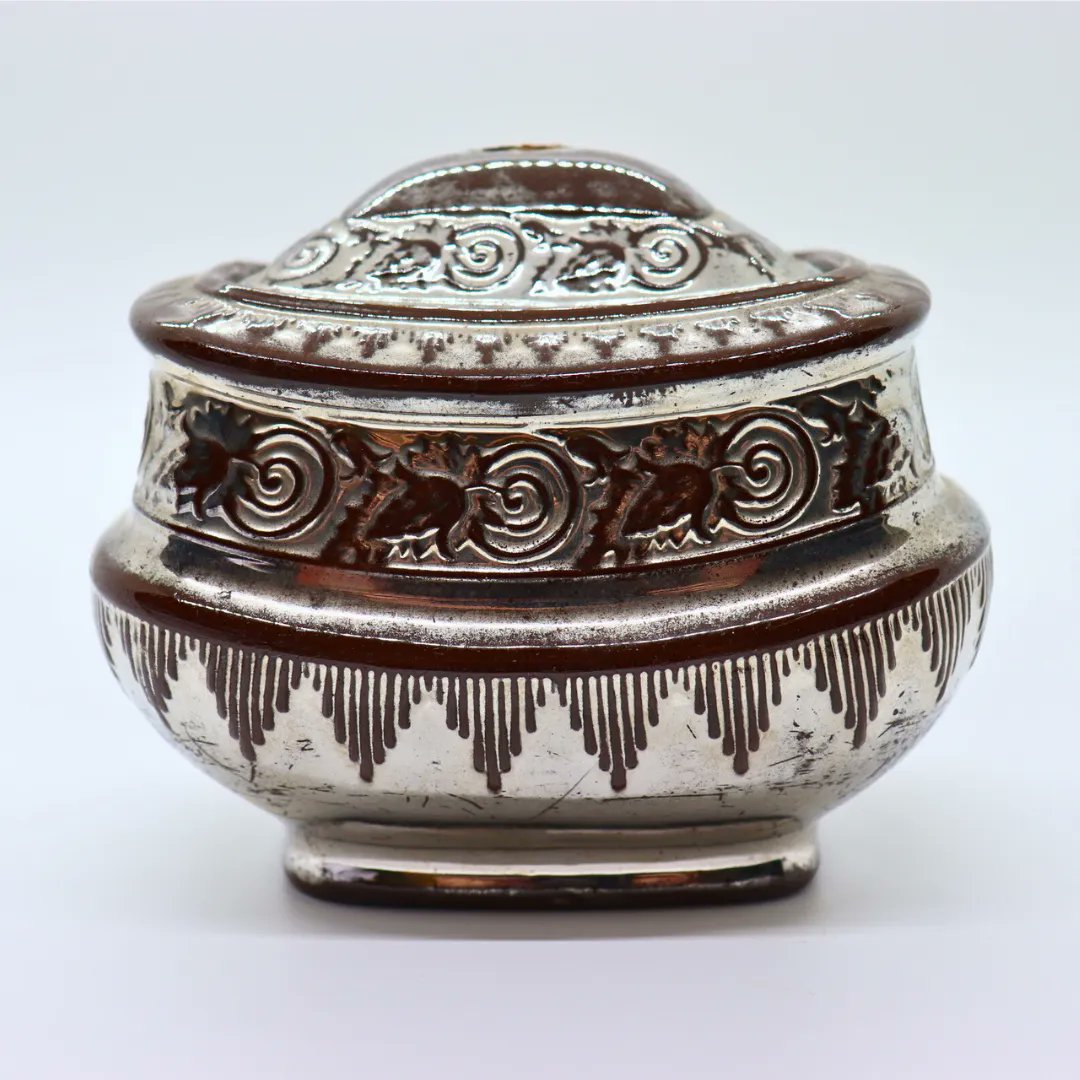 DyckmanFarm's tweet photo. This object #FromOurCollection is a sugar bowl dating to 1825-1835. It is a late classical style, rectangular gondola shaped object with raised decoration. The band under the neck is composed of leaf and vine design. The bowl is made of red clay with silver lustreware. https://t.co/i8avyo6GyI