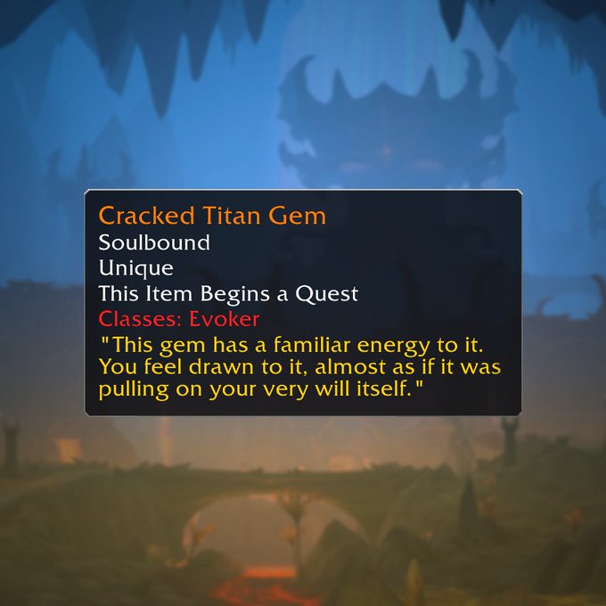 Against a blurry background of a cavernous landscape with a tower and a bridge, a text box reads the following: Cracked Titan Gem, Soulbound, Unique, This Item Begins a Quest. Classes: Evoker. "This gem has a familiar energy to it. You feel drawn to it, almost as if it was pulling on your very will itself."