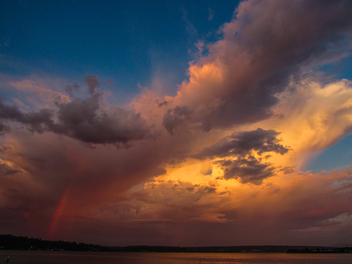 NWSSeattle's tweet photo. A decaying thunderstorm with rainbow as viewed from Matthews Beach, some sunset color, and a distant thunderstorm looking toward south Puget Sound. #wawx https://t.co/Rjwwr8m2Zu
