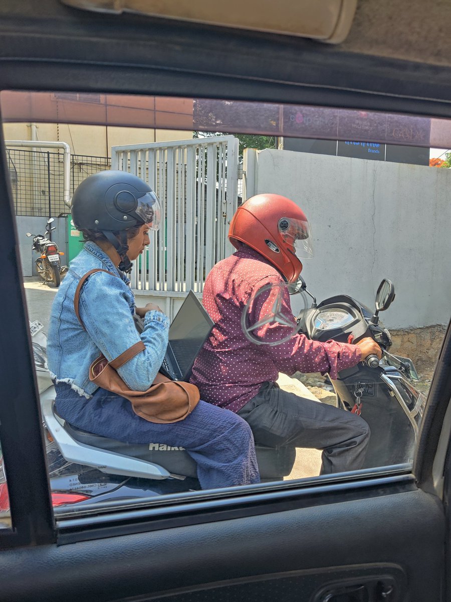 Peak Bangalore moment. Women working on a rapido bike ride to the office. #TrafficJam #TrafficAlert #bangaloretraffic #Bangalore #roadblock #peakbangalore