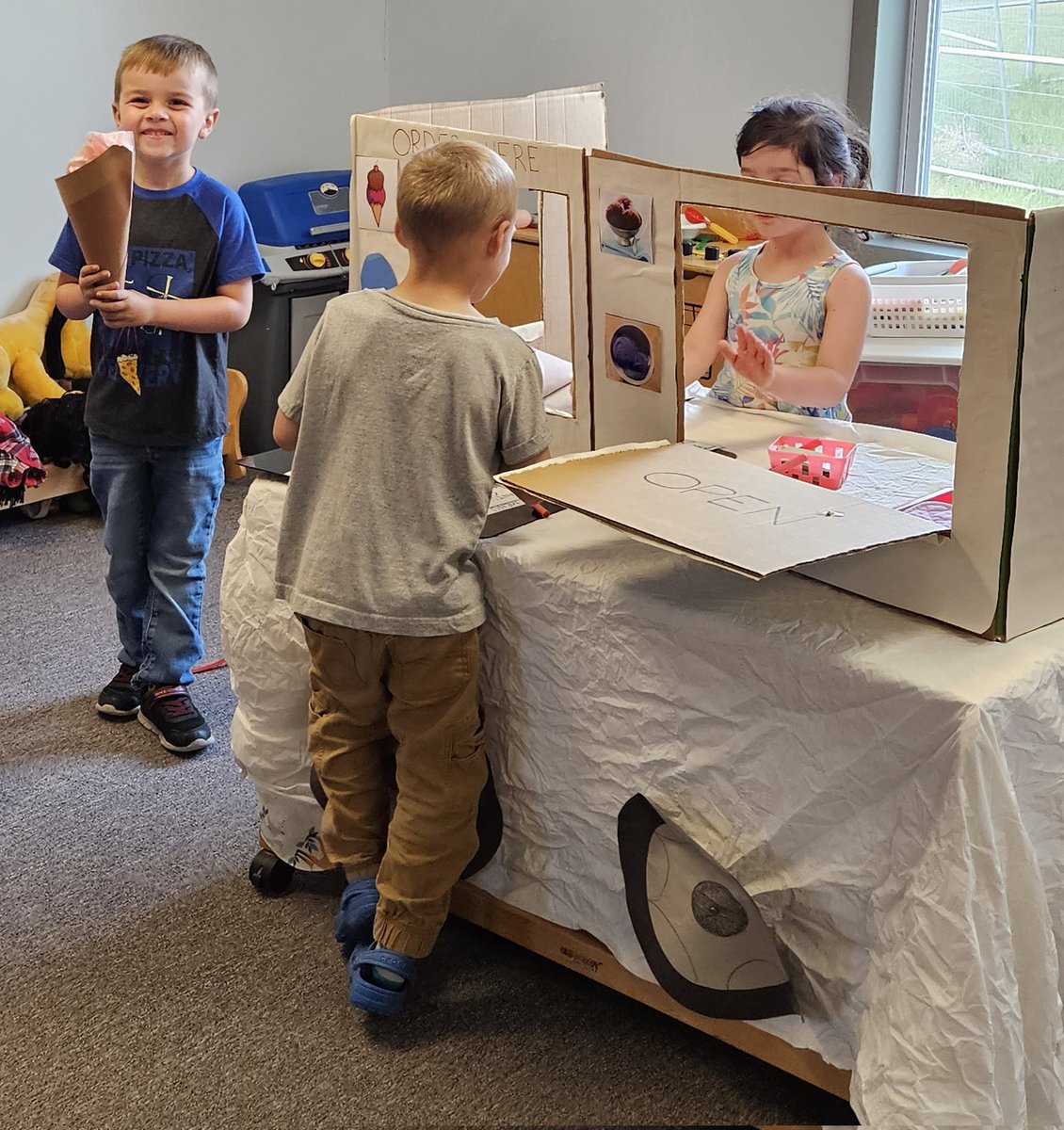 The ice cream truck has come to preK. That strawberry ice cream cone looks delicious!