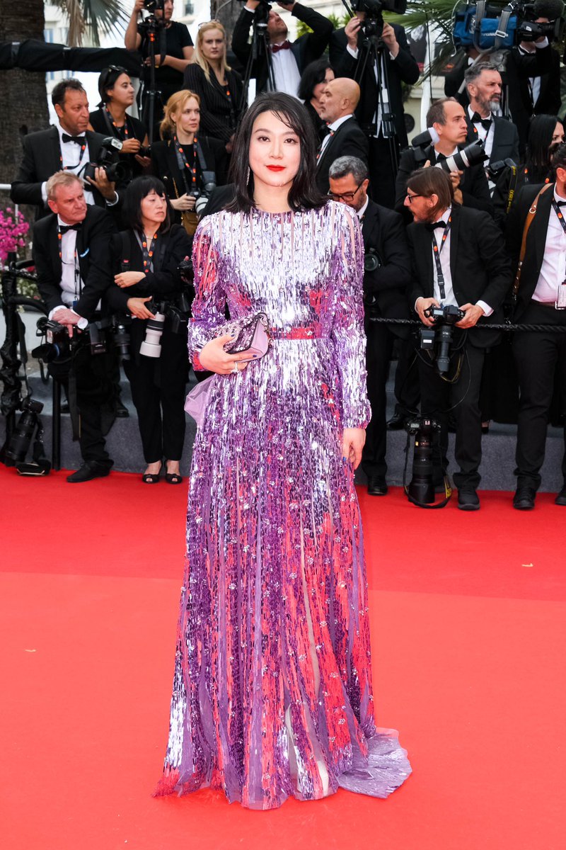#HuangLu walked the @Festival_Cannes red carpet in a purple sequin dress from #ValentinoUrbanRiviera, and complemented the outfit with the #VALENTINOGARAVANI #LocòBag