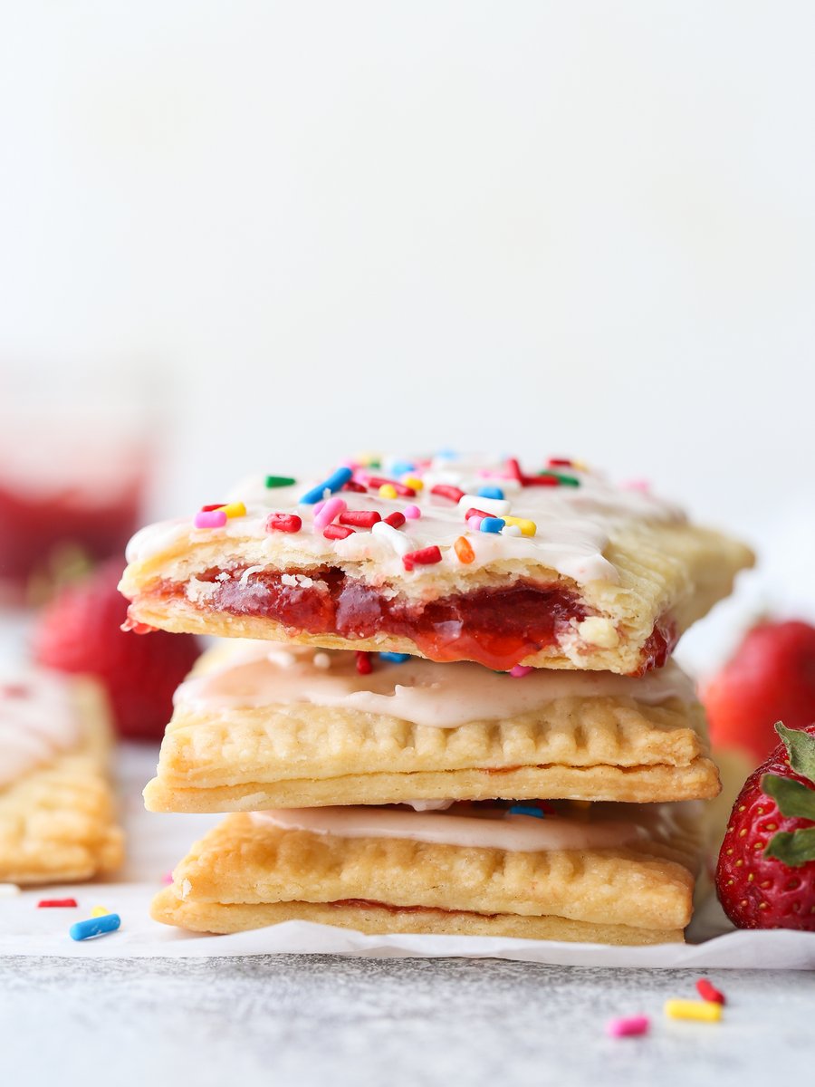 These homemade strawberry pop tarts made with strawberry preserves and flaky pastry are so much better than store-bought! completelydelicious.com/homemade-straw…