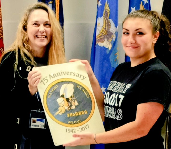 NJROTC CO c/LCDR Sara Riccardelli accepts momento from one of our favorite Substitute Teachers,Ms.Tracie Gidley.She gifted 75th Anniversary metal placard commemorating formation of US Navy's Construction Battalion,better known as SEA BEES(CB), gift from Uncle Rich Sturgis,USN.