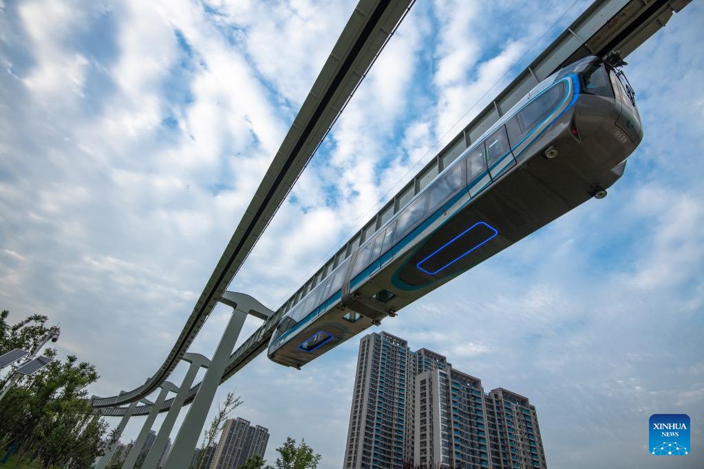 BeijingReview's tweet photo. Why China is known as the "#InfrastructureMadman"? A train running on the suspension monorail line in Wuhan, central China's Hubei Province, has undergone a running test before being put into trial operation. #ChineseInfrastructure https://t.co/TtJBgcQAJn
