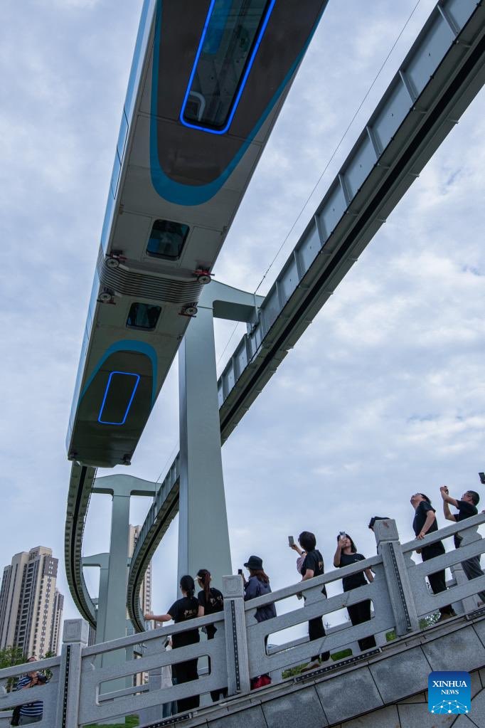 BeijingReview's tweet photo. Why China is known as the "#InfrastructureMadman"? A train running on the suspension monorail line in Wuhan, central China's Hubei Province, has undergone a running test before being put into trial operation. #ChineseInfrastructure https://t.co/TtJBgcQAJn