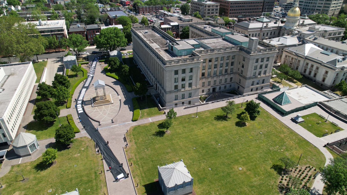 MaketheRoadNJ's tweet photo. 🔥 POWERFUL arial shots in front of @NJGov Statehouse today. 

We blanketed the streets with a 500 ft scroll symbolizing the $25 billion in annual profits wealthiest corps make off NJ.

Elected officials want give these corporations a tax break 📣We say: #FundOurFamiliesTaxAmazon https://t.co/EiBOMg8mOK
