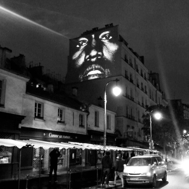 fakeshoredrive's tweet photo. 10 years ago today, Kanye West kicked off his rollout for 'Yeezus' by projecting his video for "New Slaves" on buildings across the globe.

Locations for viewings in cities like NYC, London, Paris, Toronto &amp; Chicago were announced on his website moments before the premiere. https://t.co/yZgHemAFxS