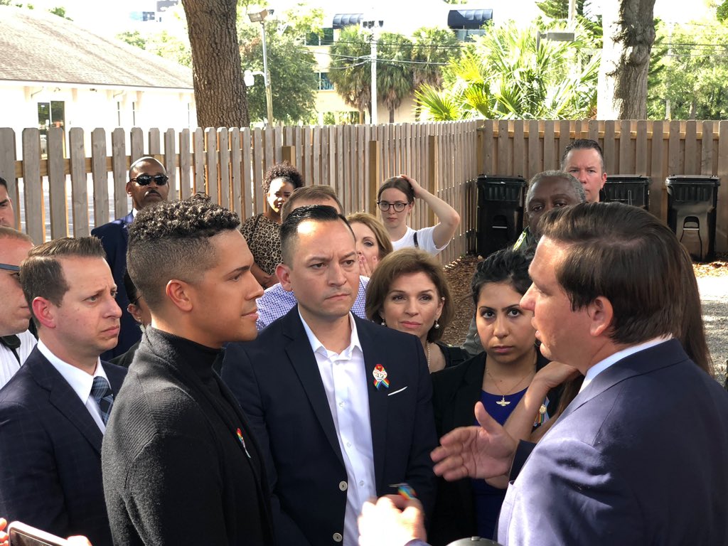 bjoewolf's tweet photo. In 2019, DeSantis came to Pulse to pay his respects. He looked me in the eye and committed to “being there for the community.” Today, he signed the largest raft of anti-LGBTQ bills in FL history.

I think you can tell whether we were buying his BS or not. https://t.co/R3PhHnurLu