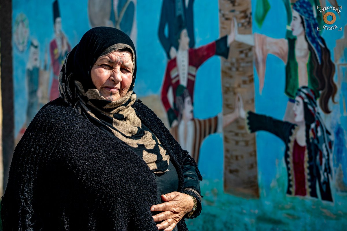 EverydaySyria's tweet photo. A woman stands in front of the cultural center in #Raqqa, showing her traditional Deq facial tattoos. https://t.co/JCOibXNFZu