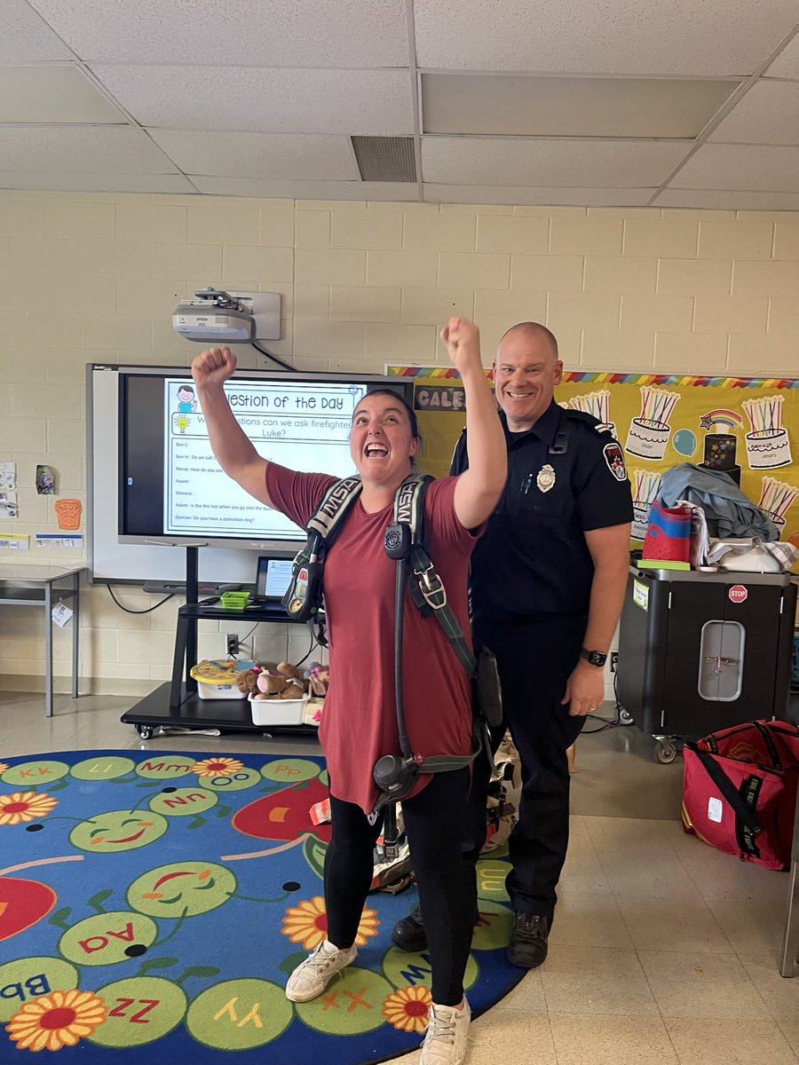 MsCormier1's tweet photo. Our visit with officer Luke yesterday! We had some great discussions around fire safety!  Mrs . Mac and myself also got to try on the gear, and boy is it heavy! @ALXCoyotes https://t.co/A70ZXOsuCU