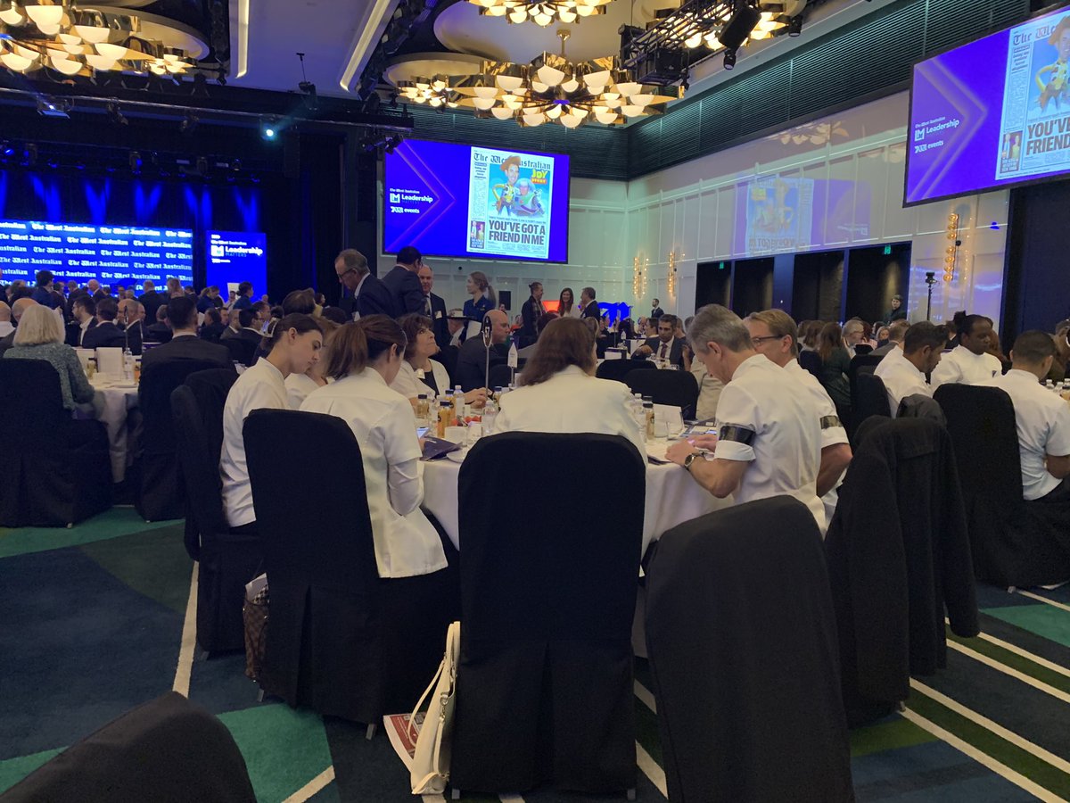 RussellJQuinn's tweet photo. Good turnout for @westaustralian #LeadershipMatters breakfast with Federal Treasurer Jim Chalmers. Interesting #protest from #pharmacists unhappy with revised medical policy #questionsforJim https://t.co/WKD7Ajzl0z