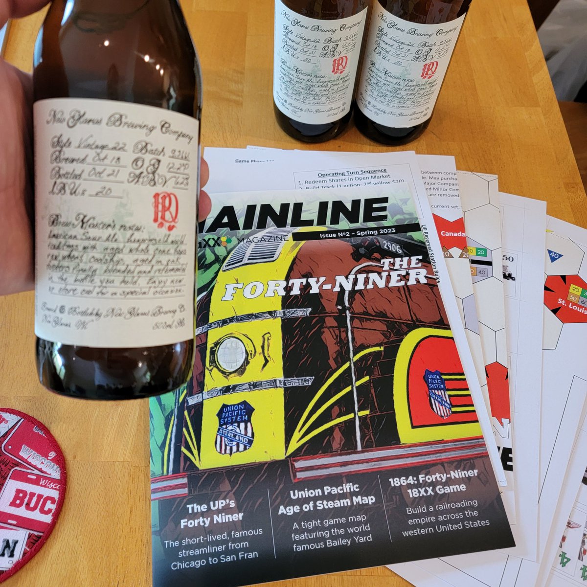 GameMadison's tweet image. @GameMadison what a day, not only did I pick up a couple bottles of the Gold Medal (world beer cup) winning vintage 22, my copy of Mainline was waiting for me when I got home! The signs are clear, it's time to sit back with a drink and read! @18xx_TraXX @newglarusbrew #18XX #CCMF