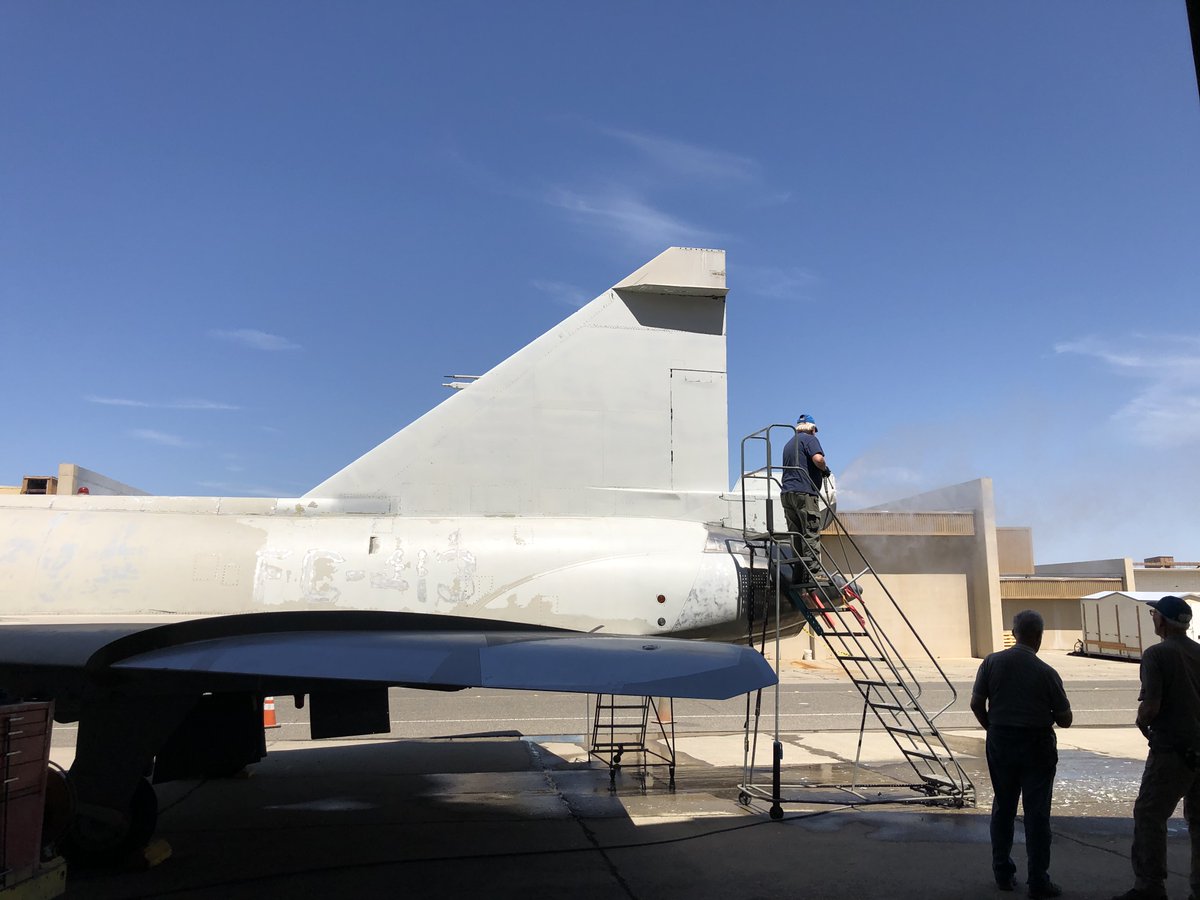 CastleAirMuseum's tweet photo. Restoration volunteers on Friday removing all old loose paint prior to the Delta Dagger’s repainting coming up very soon to get the aircraft back on display. Of interest the F-102 was first fighter interceptor aircraft with an internal weapons bay. https://t.co/l29VGrGj4R