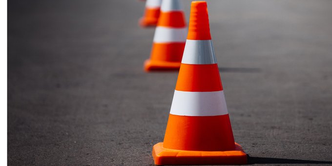 Photo of a traffic cone on a road.