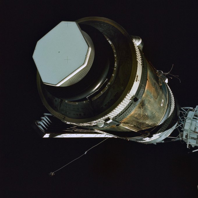 Skylab 2 took this photo of the Skylab space station on May 24, 1973 as it did its fly-around inspection. The Orbital Workshop is missing the micrometeoroid shield, revealing the golden surface of the workshop. Stray wires on the right indicate the spot where one of the solar arrays was ripped off on launch, and in the lower part of the photo, the second solar array is still folded and only partially deployed. Photo credit: NASA