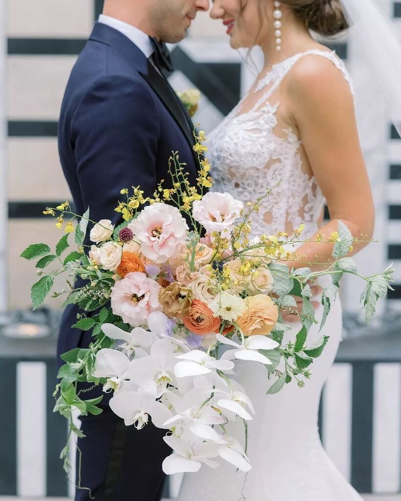 These beautiful pastel details on this wedding bouquet are giving us all the feels. All hail to the happy couple! 🥂 
Planning + Design + Florals: @burlapandbordeaux
Photography: @redamancyphotofilm
Linens: <a href="/dreamsamerica/">Dreams America Linen</a>
DJ: @alekseichebeliuk
Cake: @chefsvengarrett

#wedding…