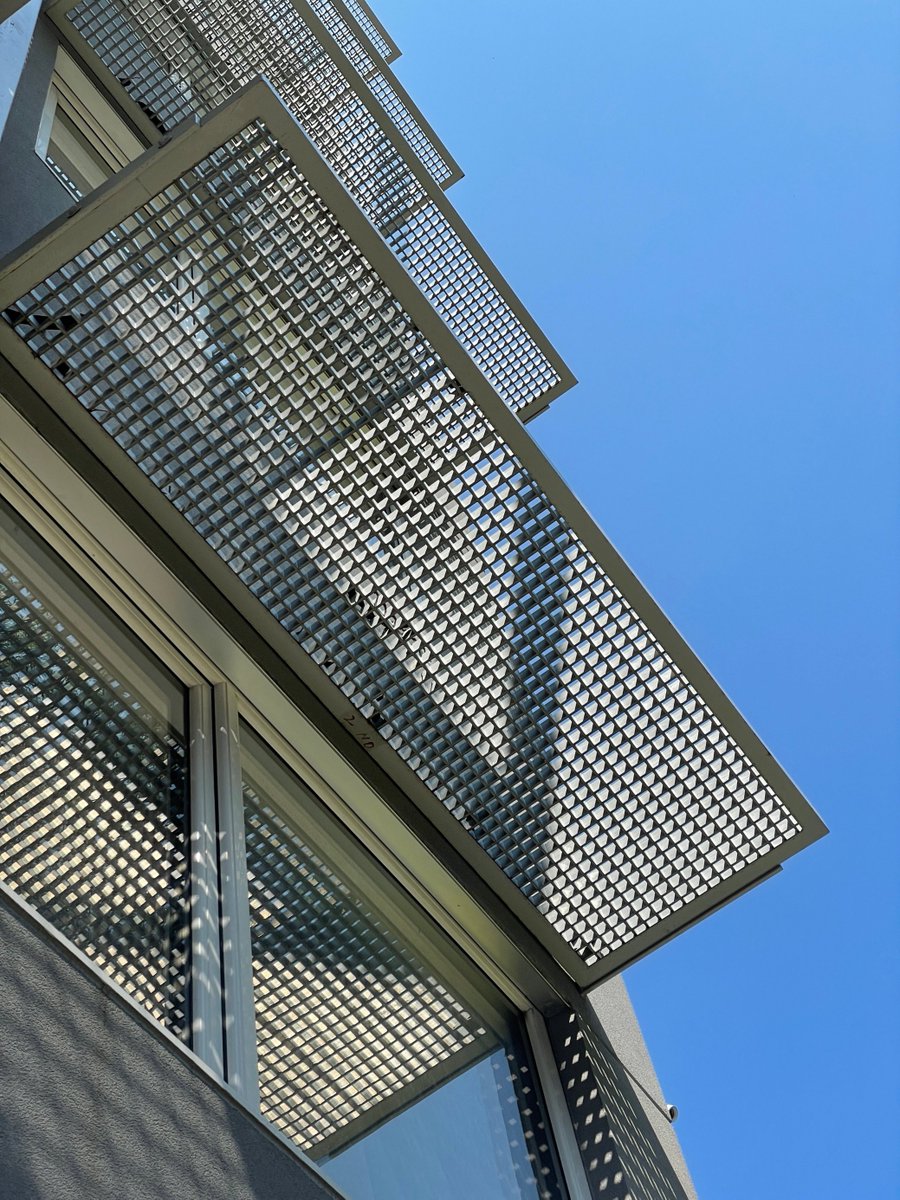 Custom egg crate sunshades were designed for this multifamily passive house to reduce solar gain while maintaining the views. 

#ZHarchitects #Architecture #Moderndesign #passivehouse #sunshade #edwardcarusophoto